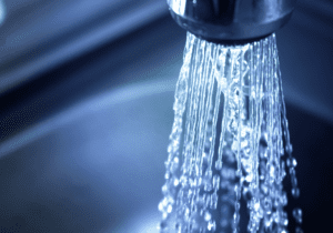 Faucet water pours in a clear stream.