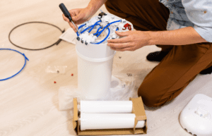 person assembling a water filtration system